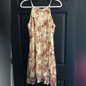 Cream colored dress, covered in lacy detail with muted pink roses, mini